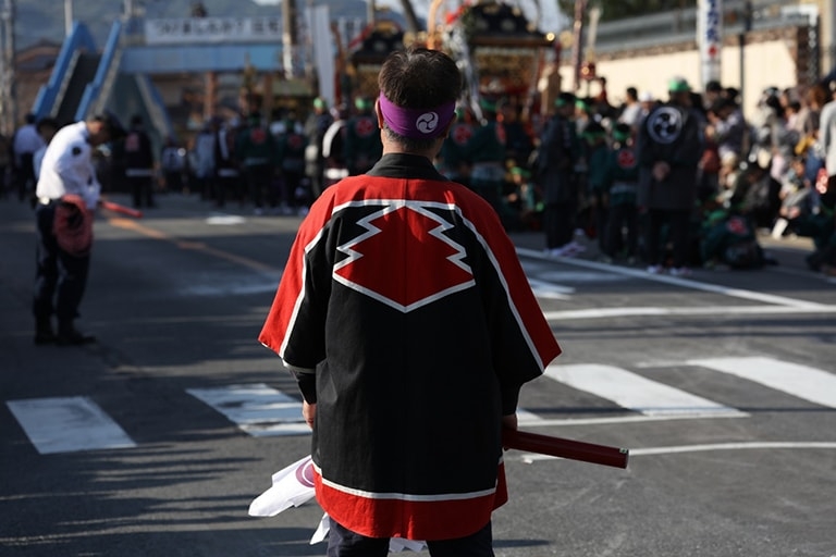 Person in Japanese traditional festival clothing standing in a street