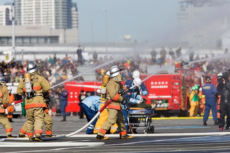 Fire fighters with hoses putting on a demonstration