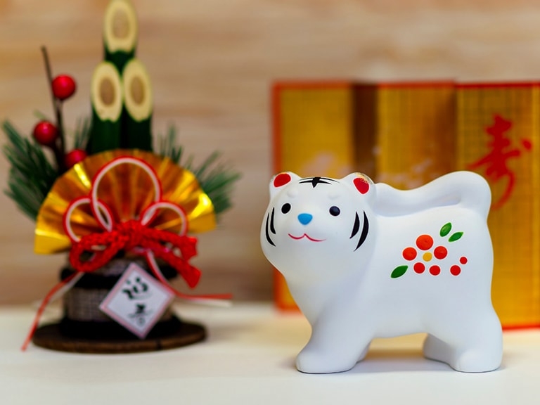 A ceramic white tiger next to a New Year display