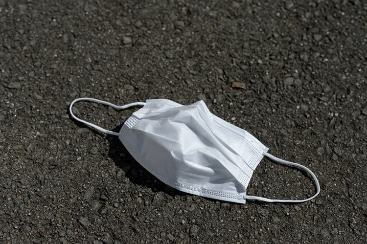 A discarded mask laying on the ground