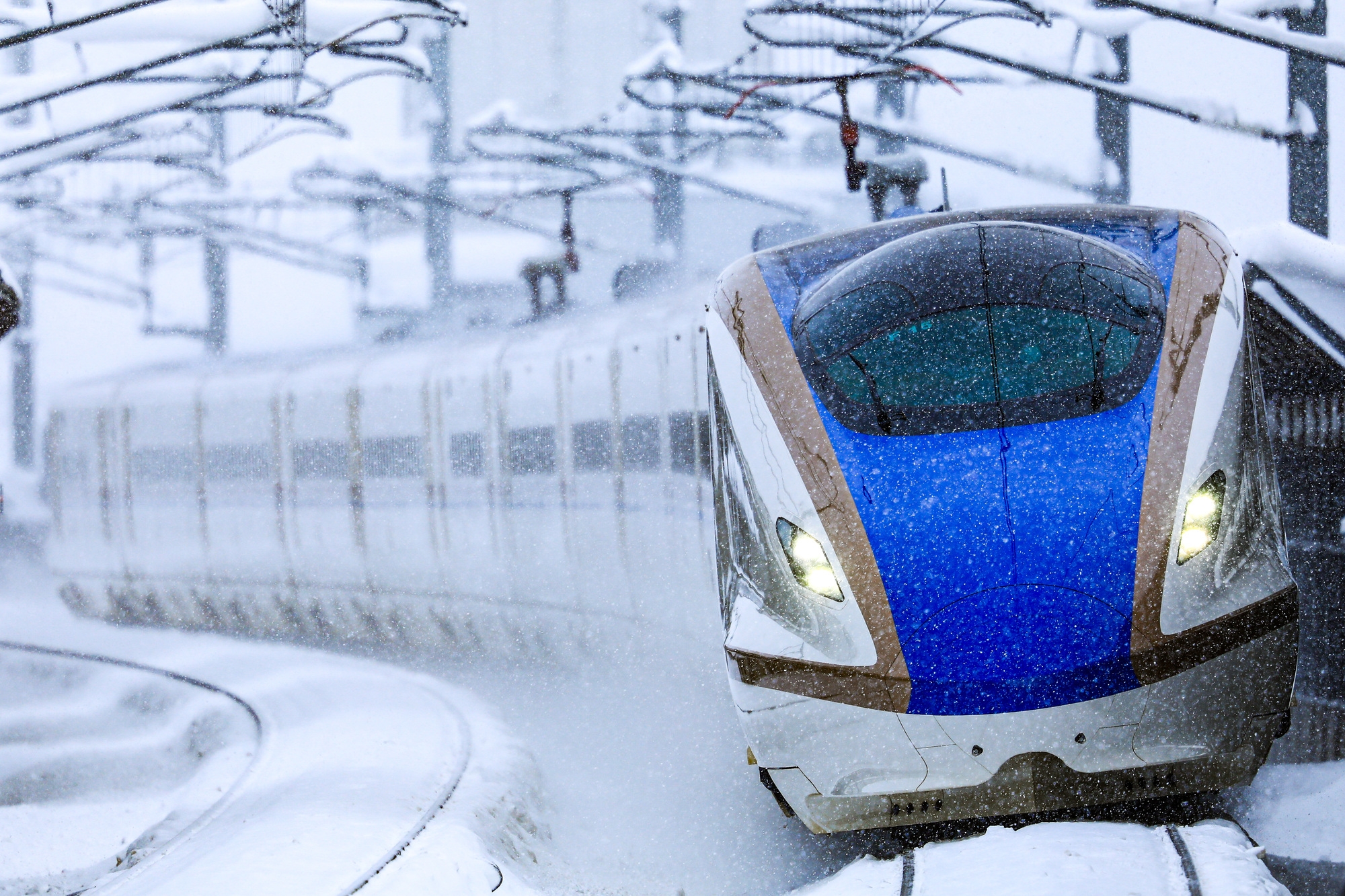 A Hokuriku Shinkansen train drives through heavy snow