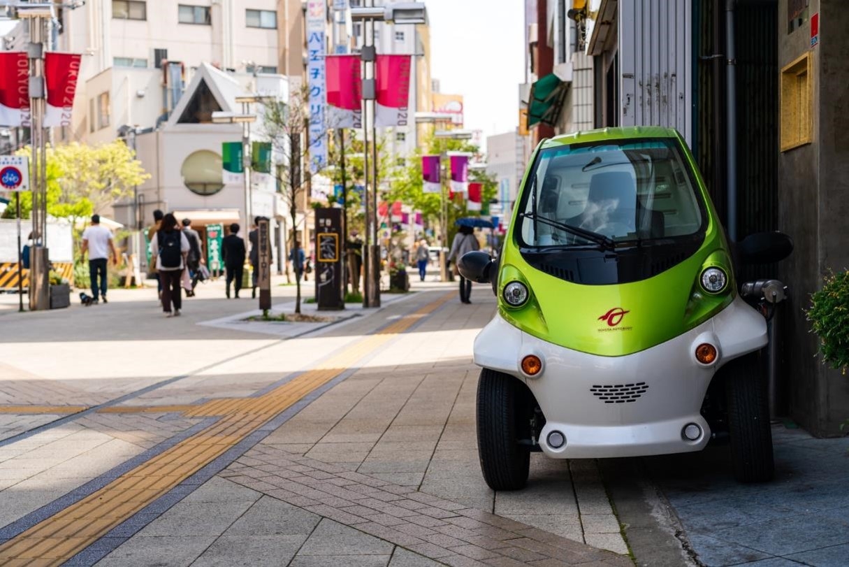 An ultra-compact delivery vehicle parked by the road 