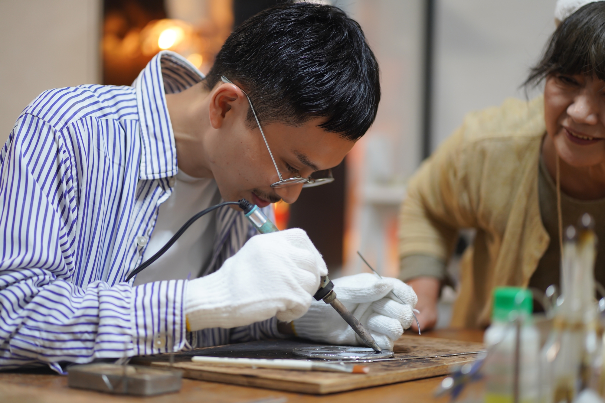 A person making stained-glass art