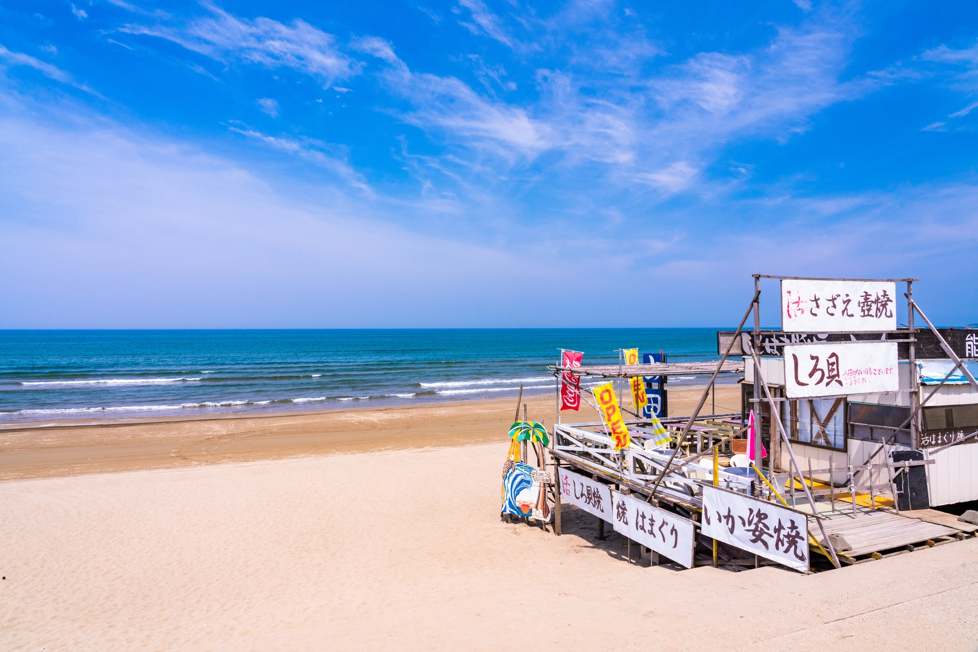 A wooden beach shop selling a variety of summer goods