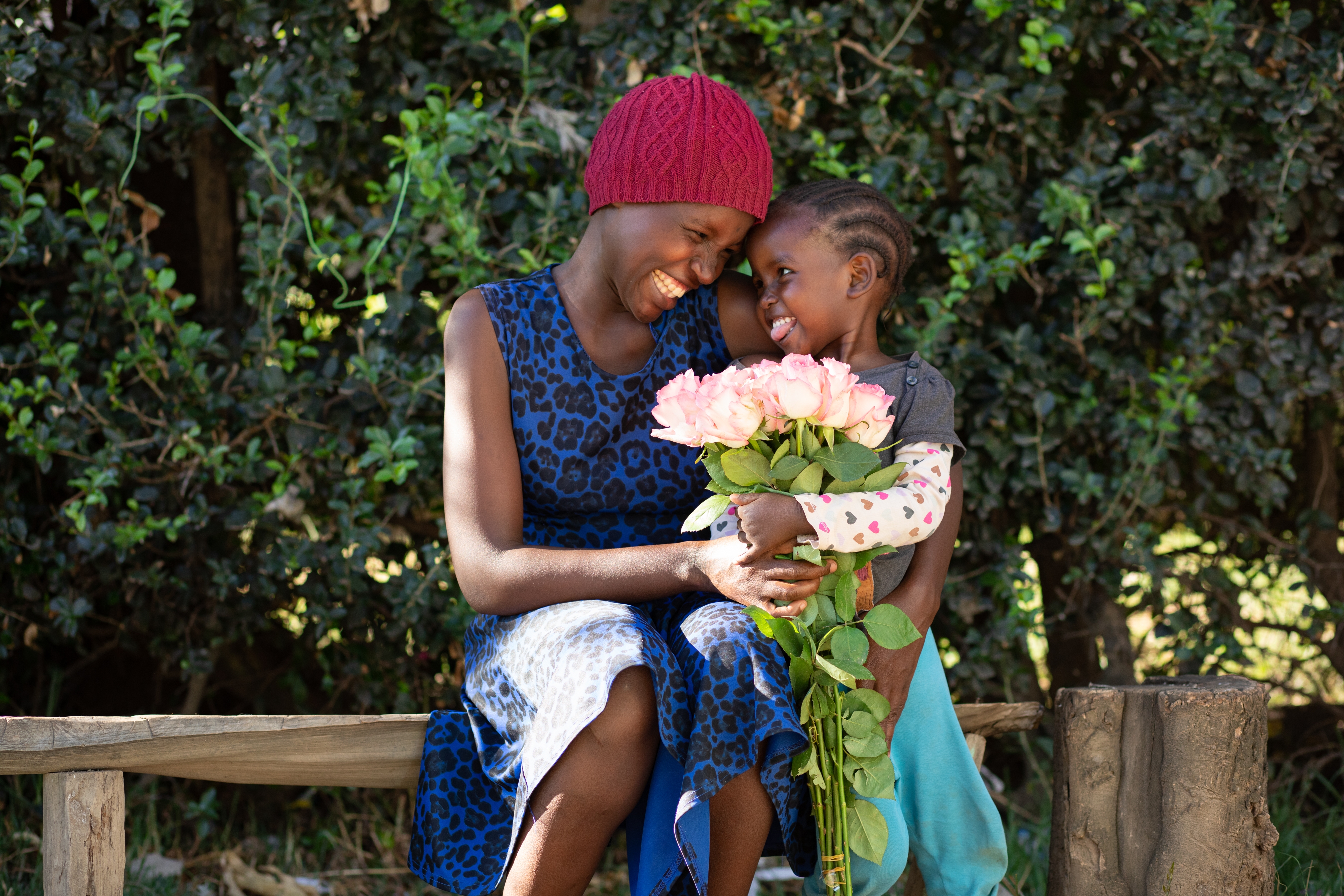 A mother and daughter holding roses