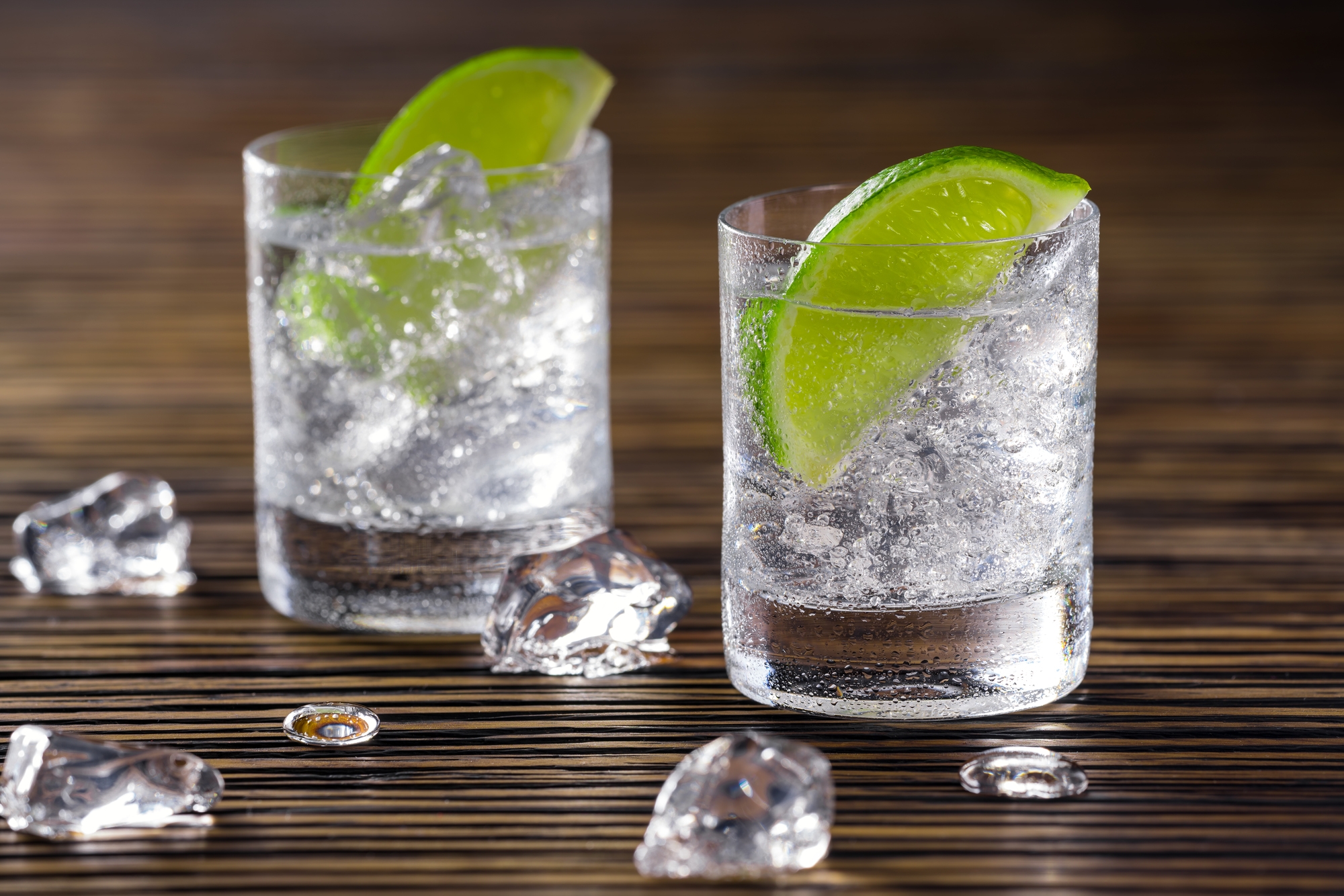 Two glasses of alcohol with lime