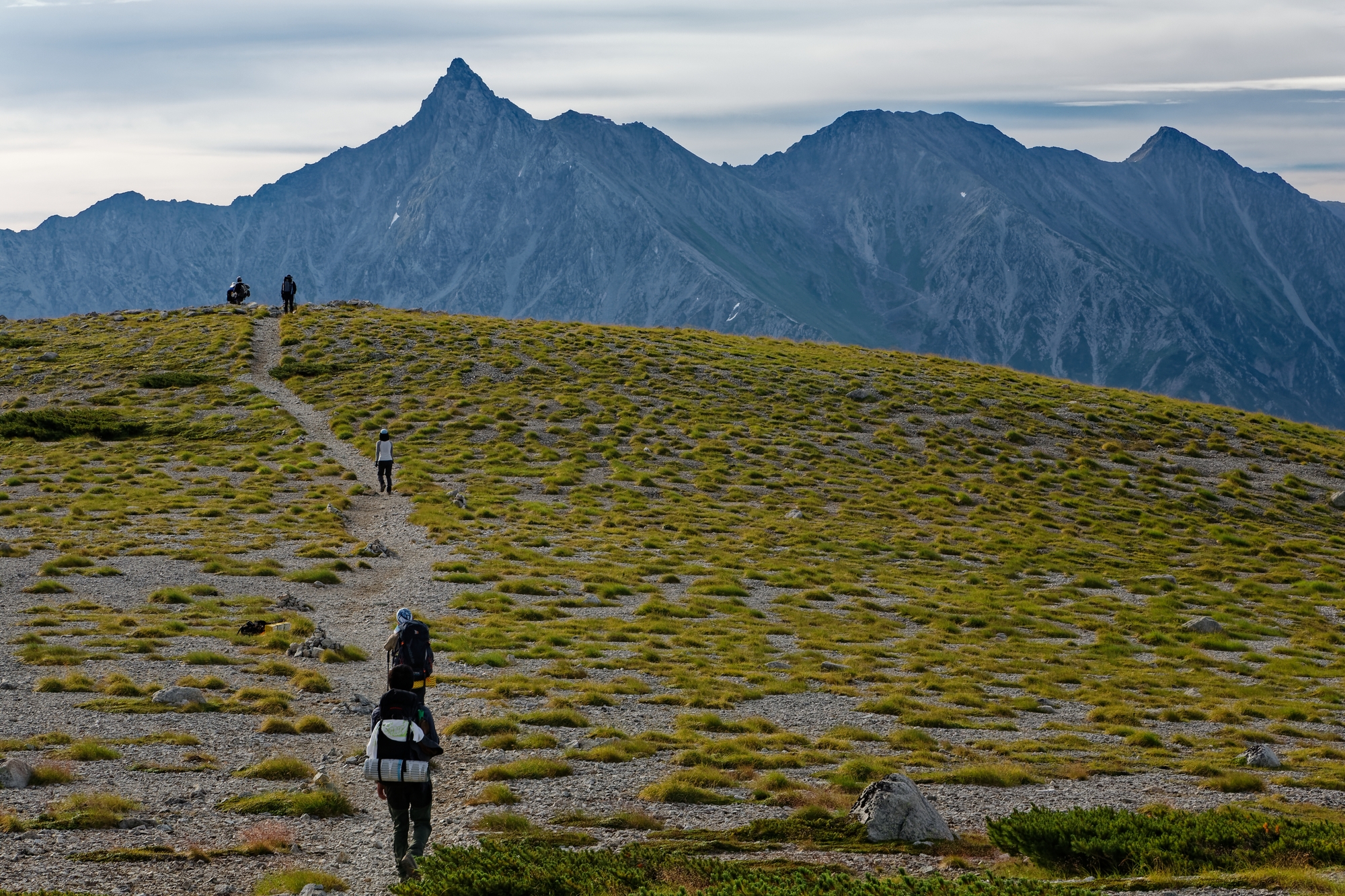 Hikers walking along a trail on Yarigatake mountain