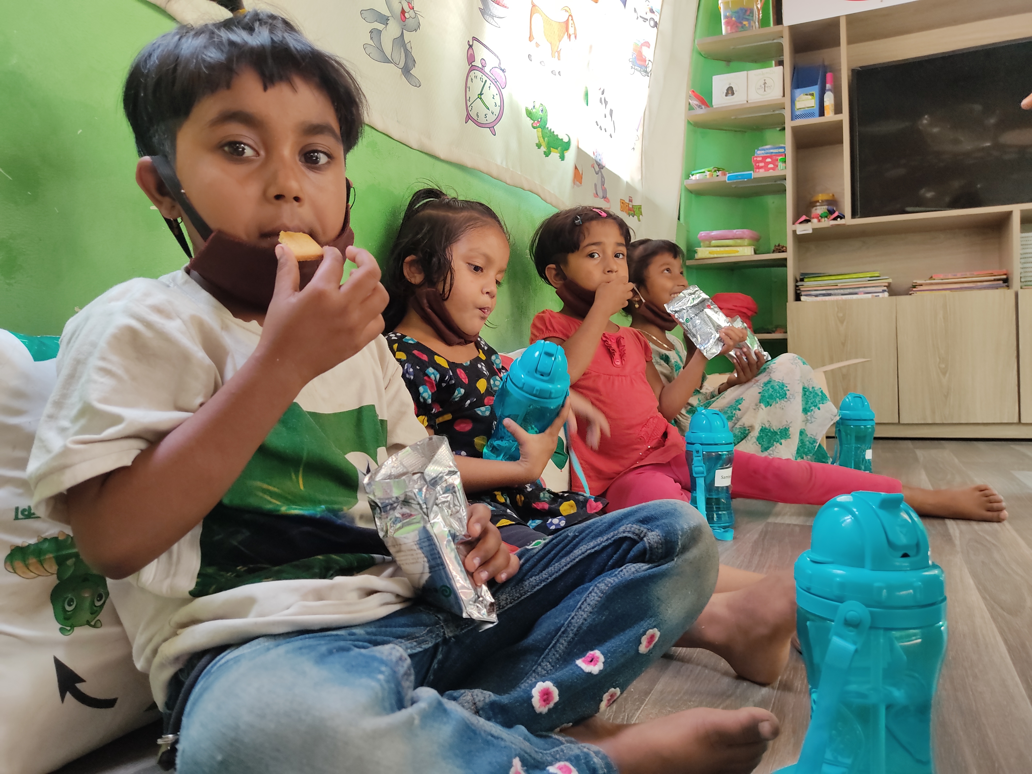 Children in a school eating cookies