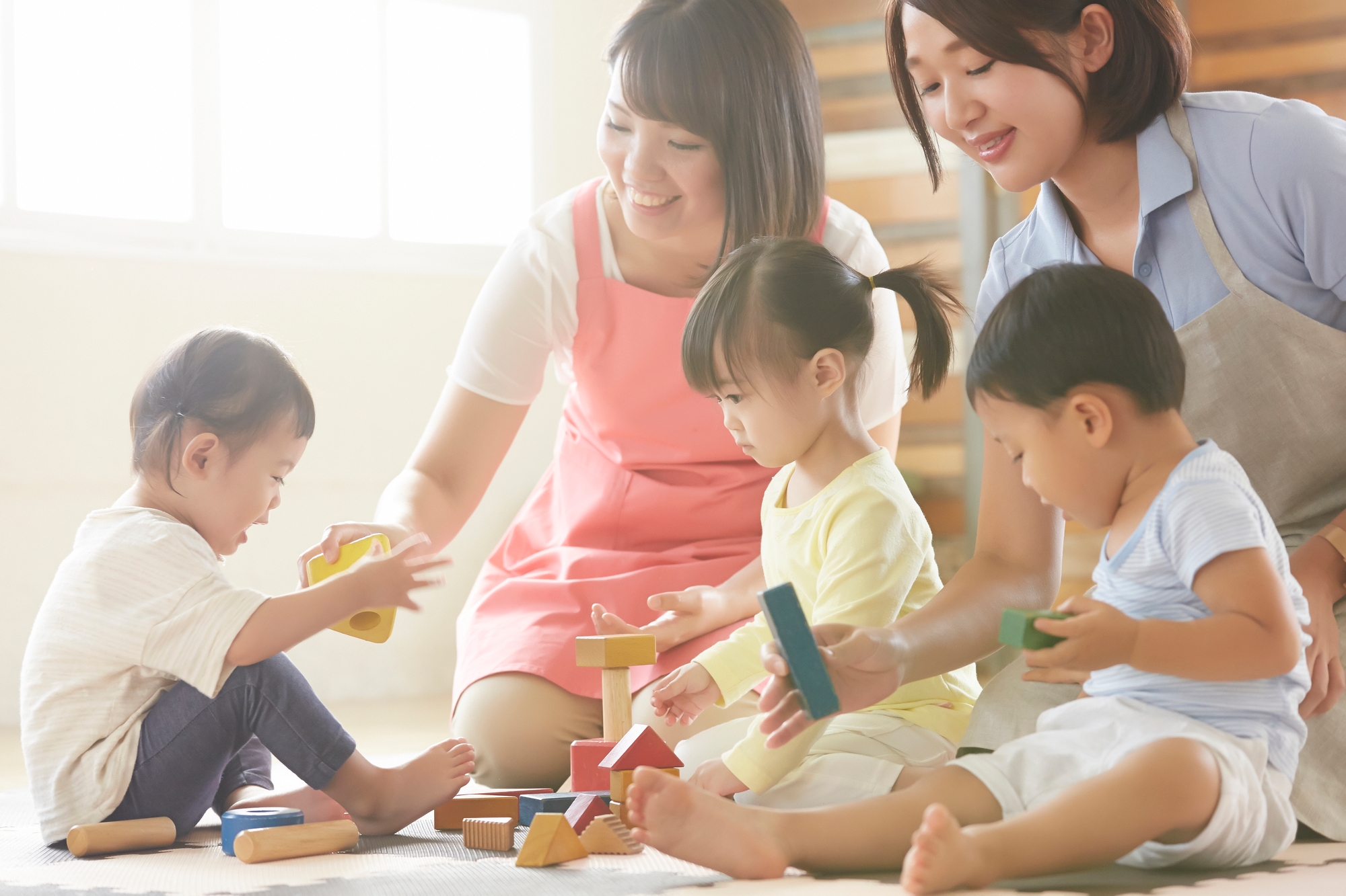 parents and daycare workers taking care of young children