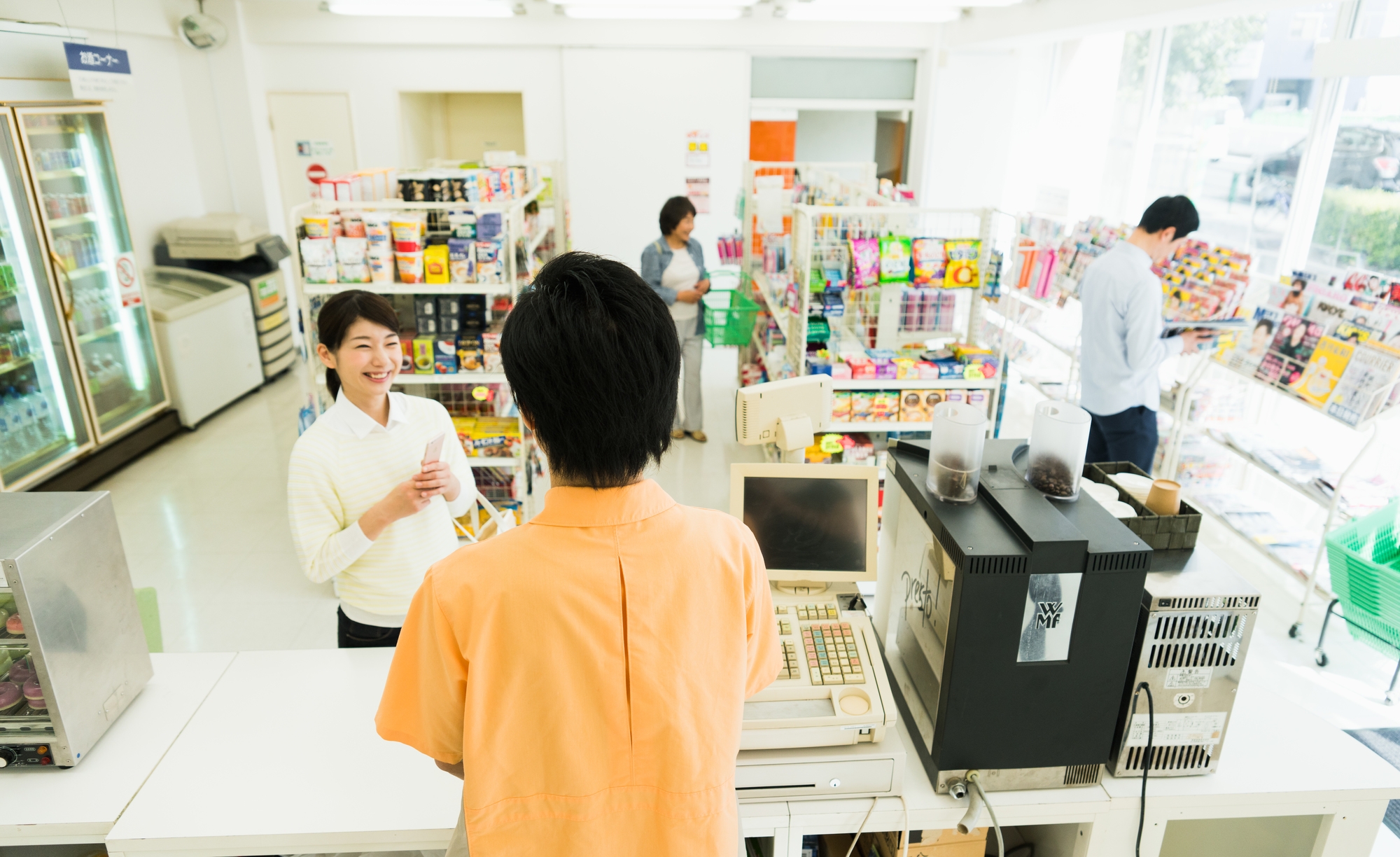 A customer making a purchase in a convenience store