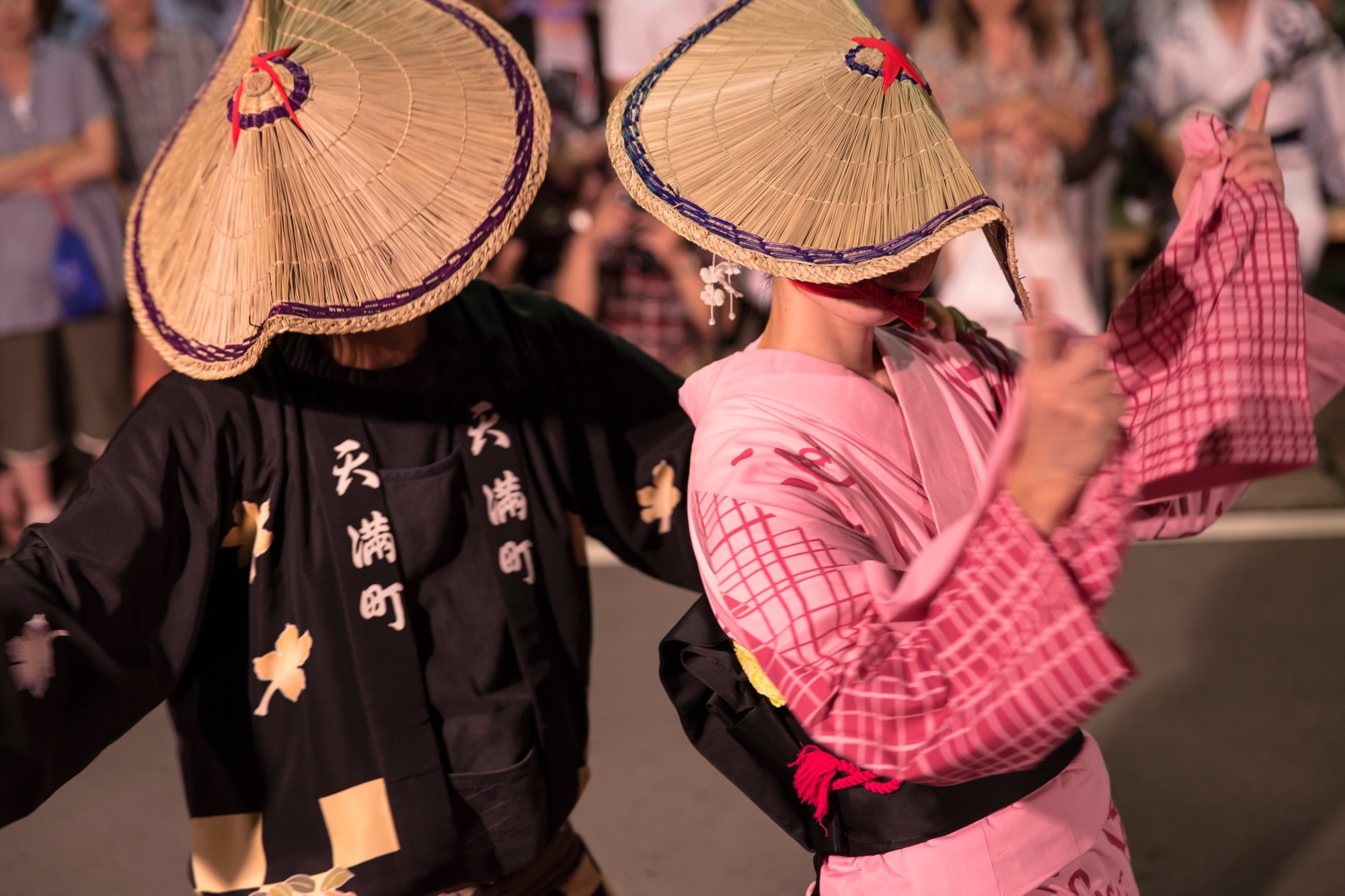 Men and women dancing with their faces covered