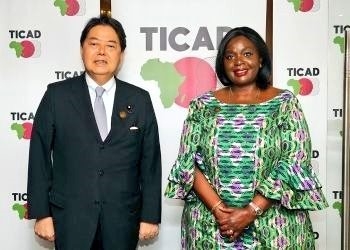 The Japanese Foreign Minister standing with the Kenyan Cabinet Secretary, Ministry of Foreign Affairs,  Raychelle OMAMO at TICAD8 in Tunisia