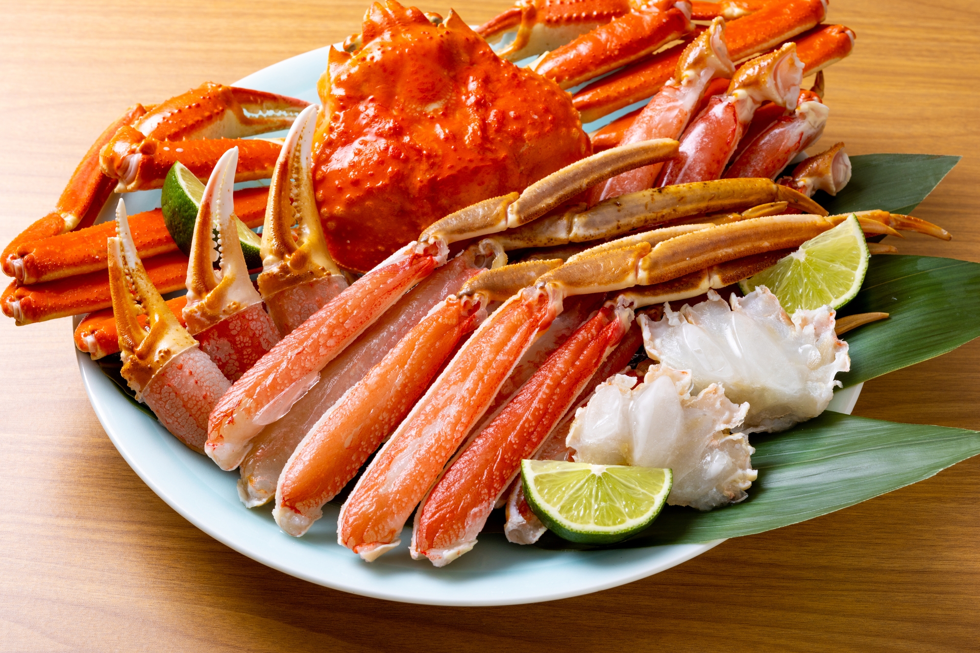 A large crab and crab legs prepared in a large dish