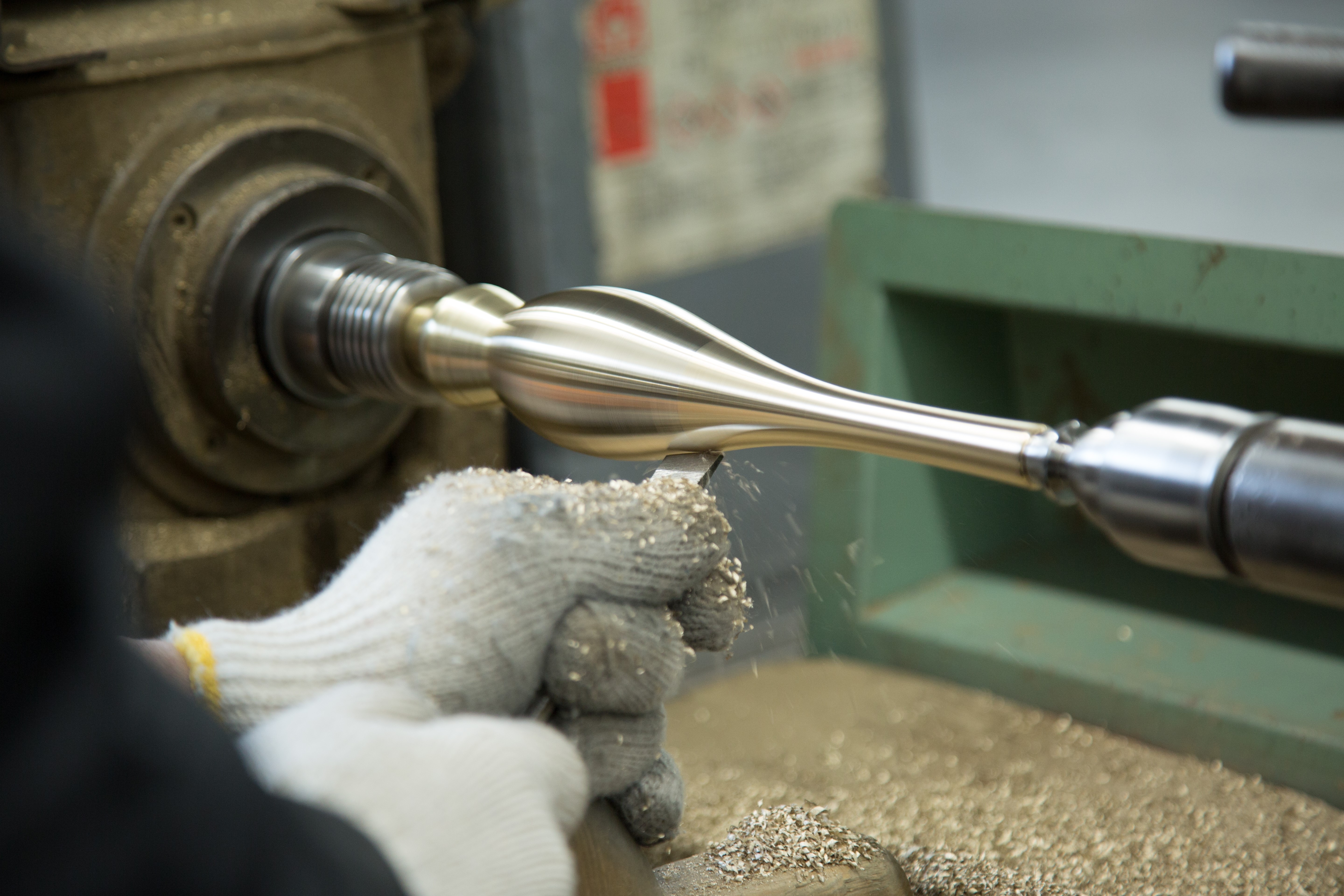 A piece of metal material being turned on a lathe