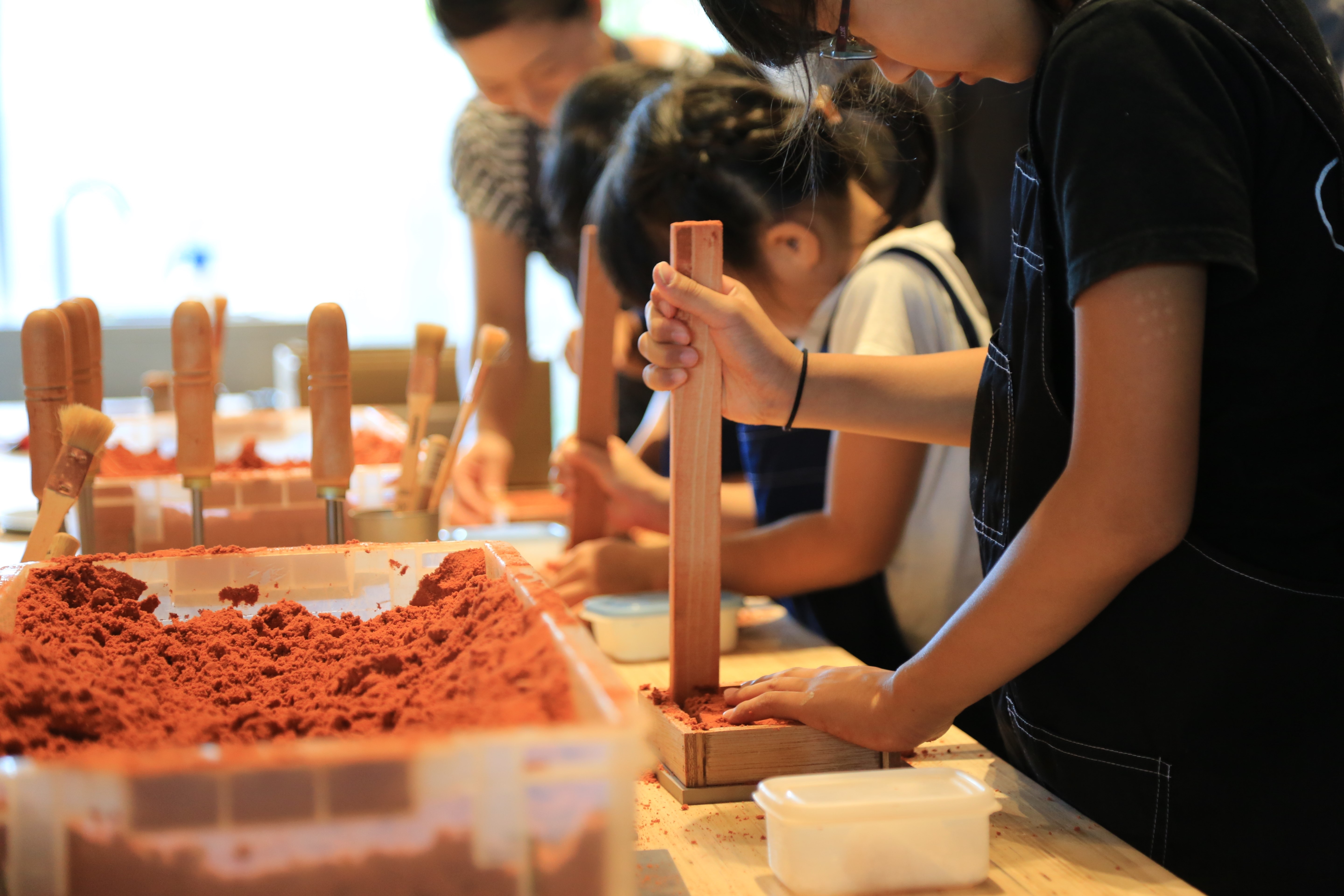 Children learning how to make traditional crafts