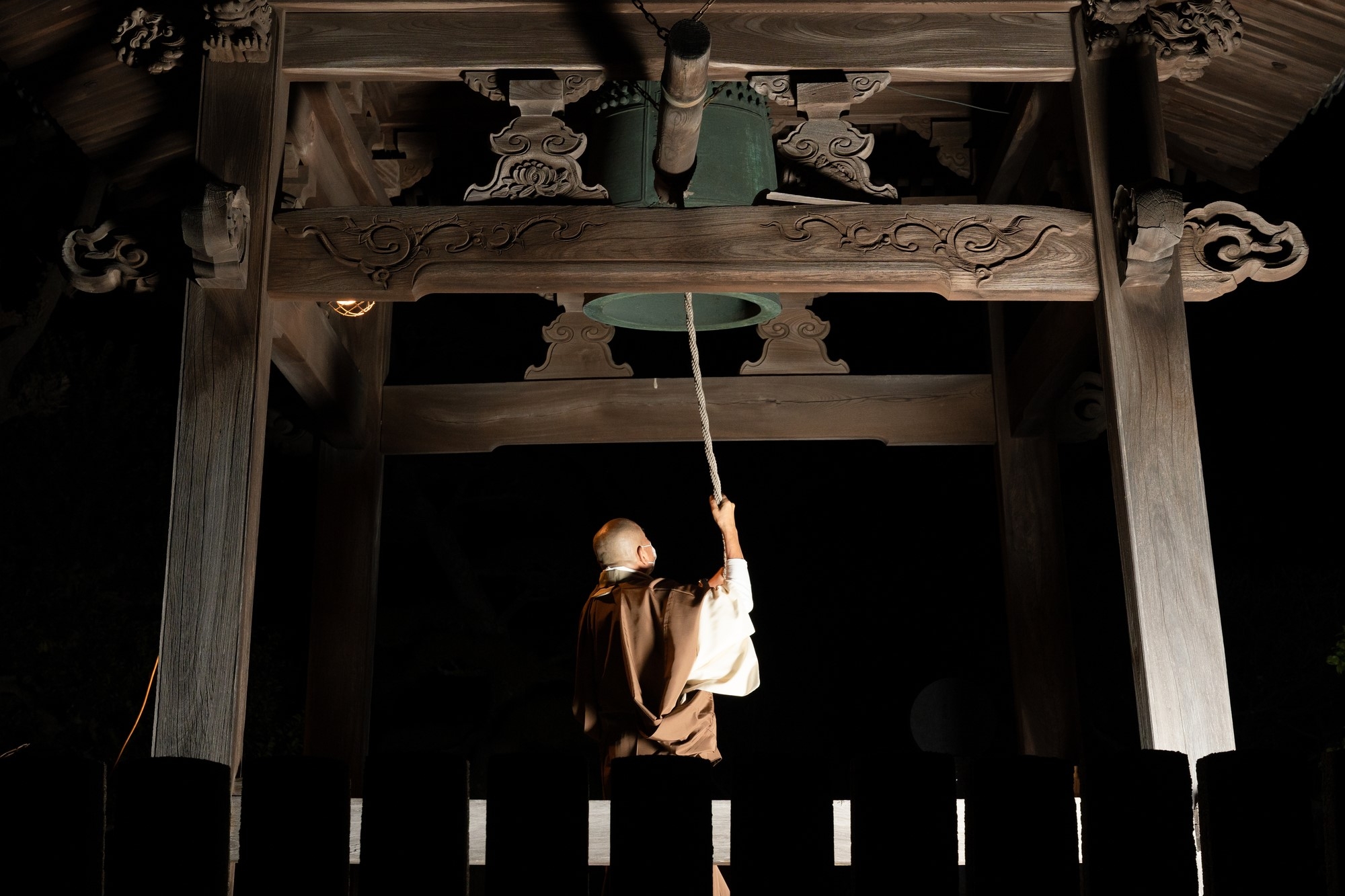 A Buddhist priest ringing a large copper bell on New Year's Eve