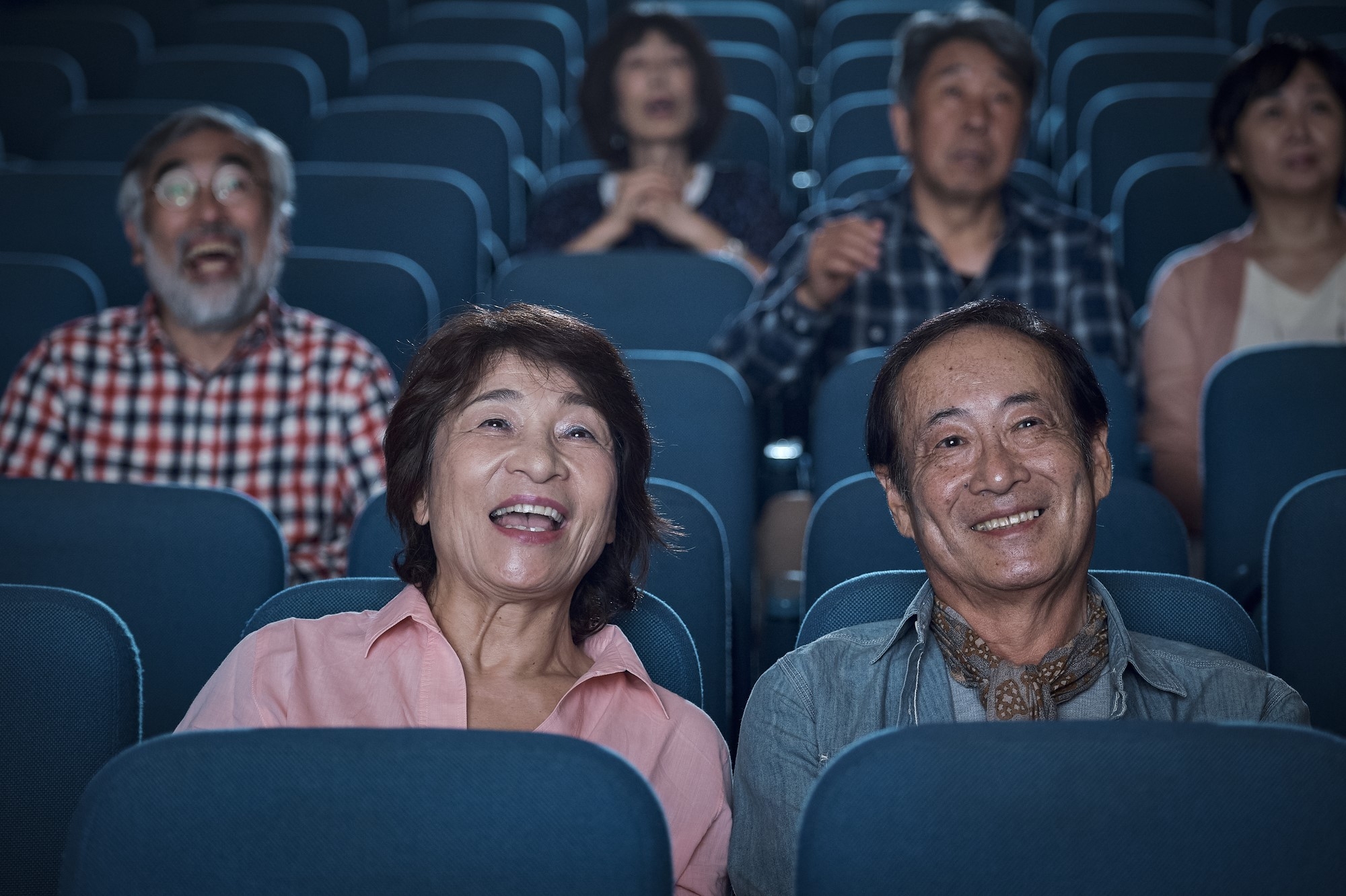 Japanese people in a cenima watching a movie