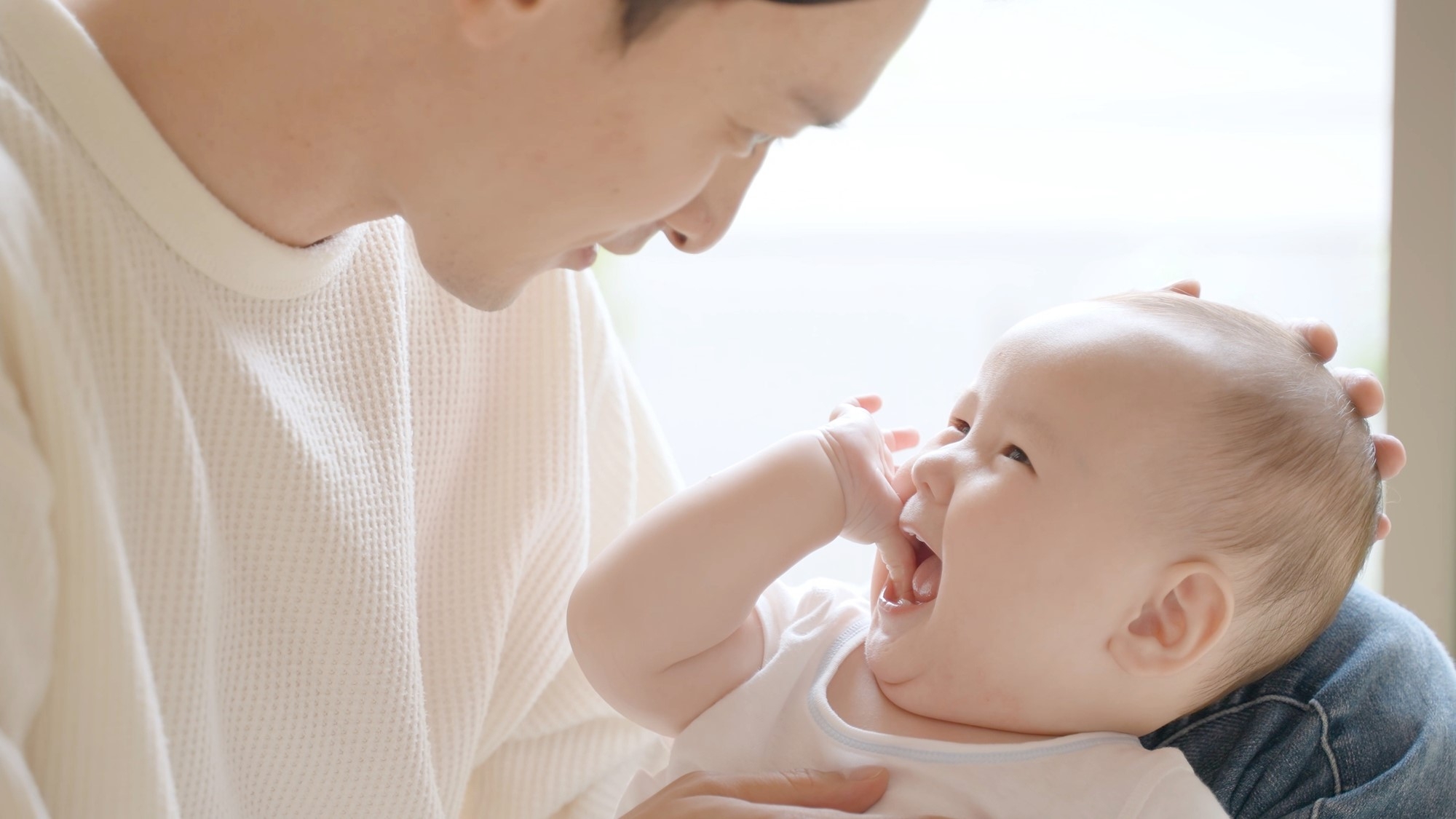 A father holding a small baby