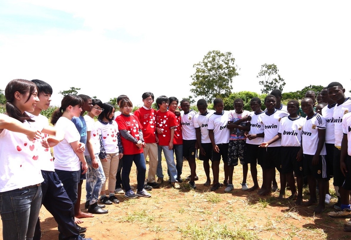 Members of MPJ Youth playing sports outdoors with schoolkids in Ghana 