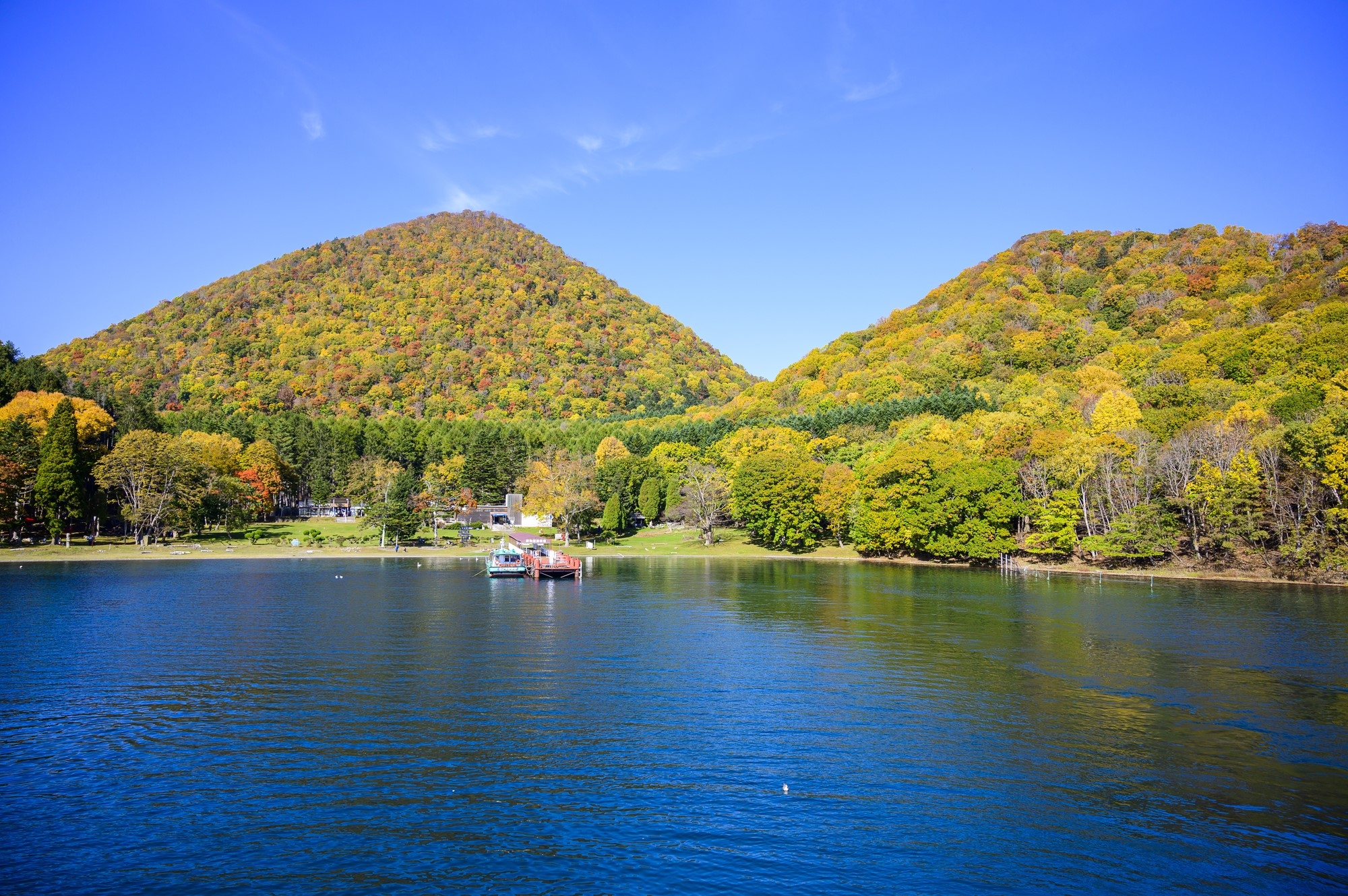 Lake Tpya, with forest-covered hills in the background