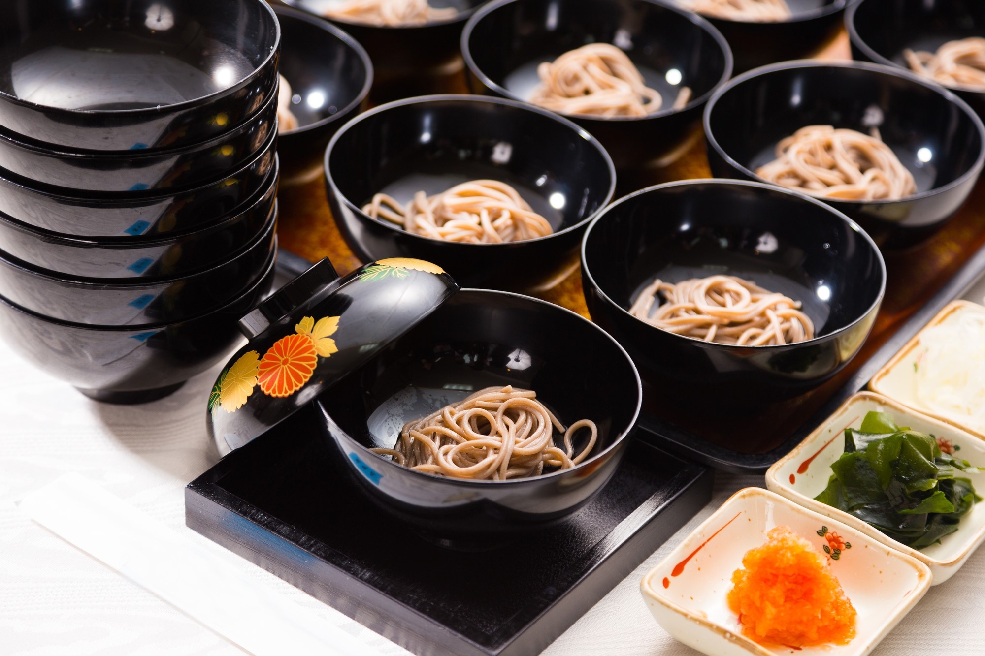 A large array of bowls of wanko soba