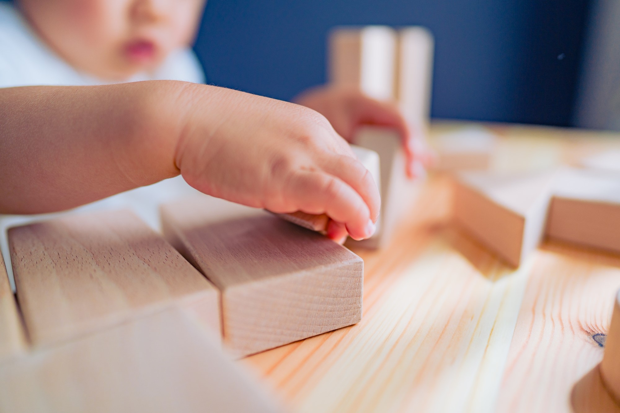 A child playing with wooden toy blocks