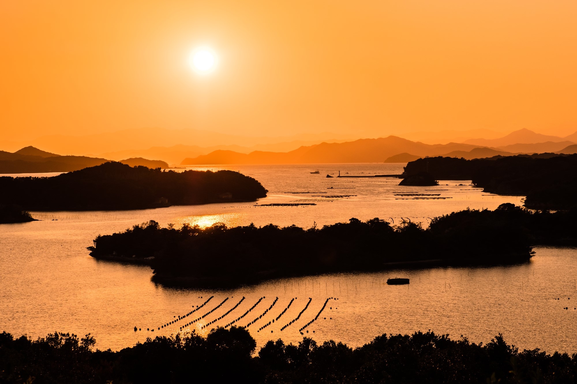 The sunset over Shima, with a pearl farm in the foreground