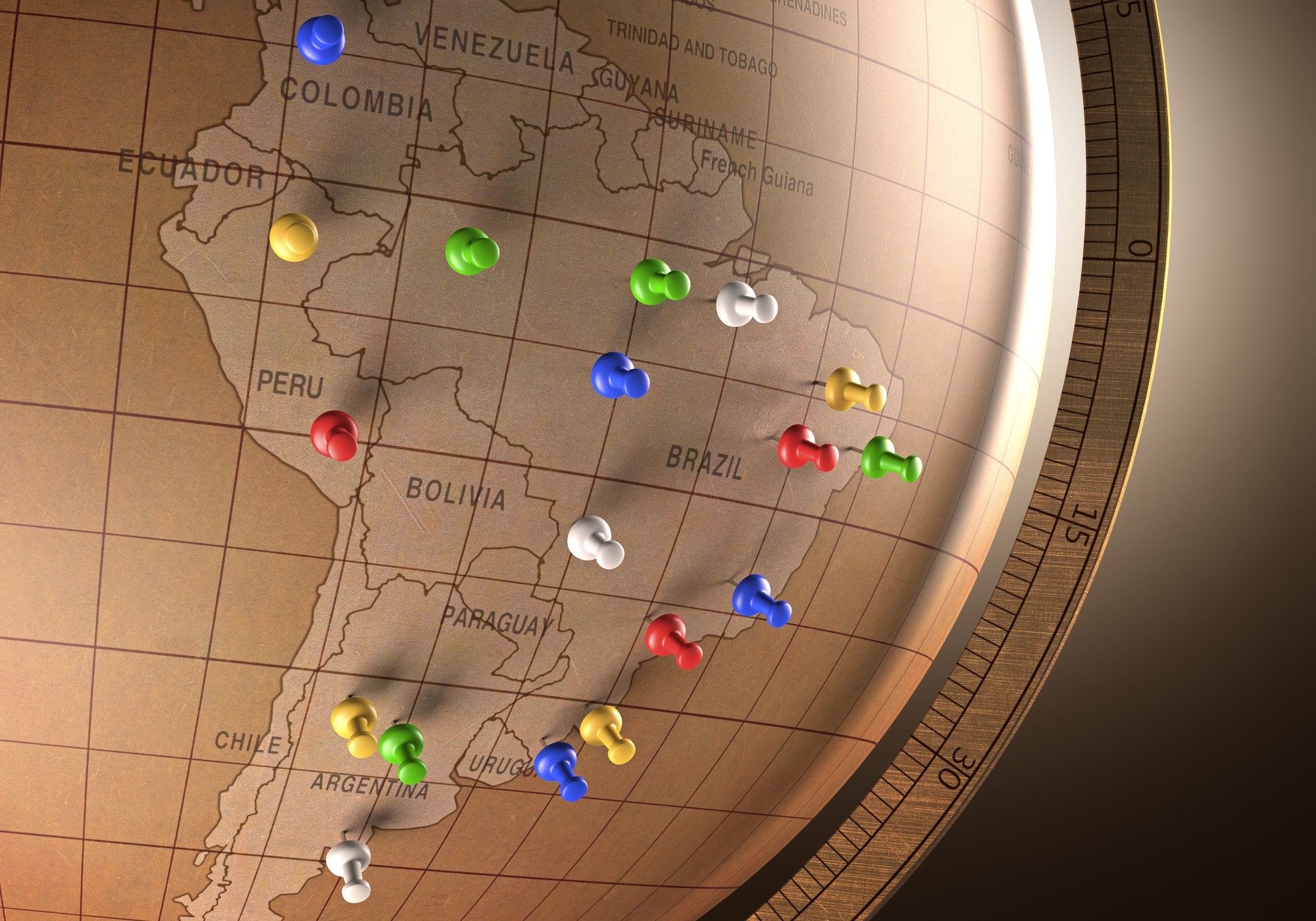 A globe focused on South America, with several push-pins inserted