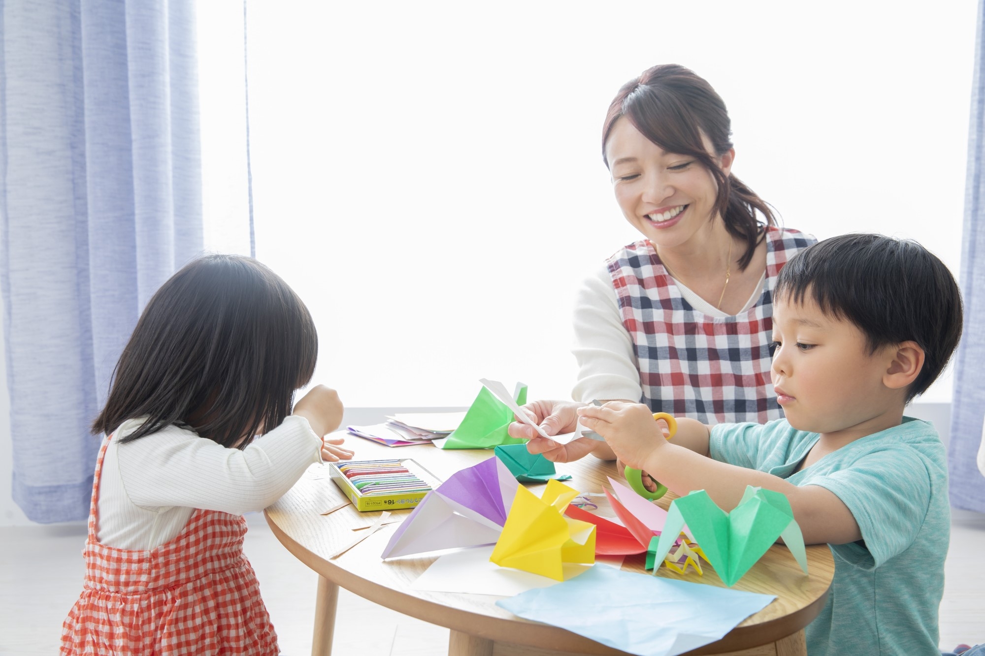 Kids learning to fold origami