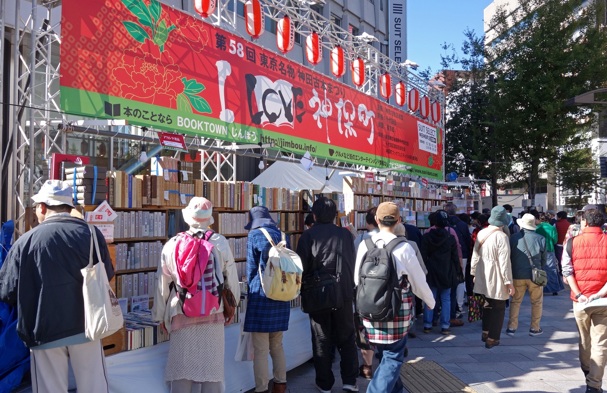 People picking up books on a street