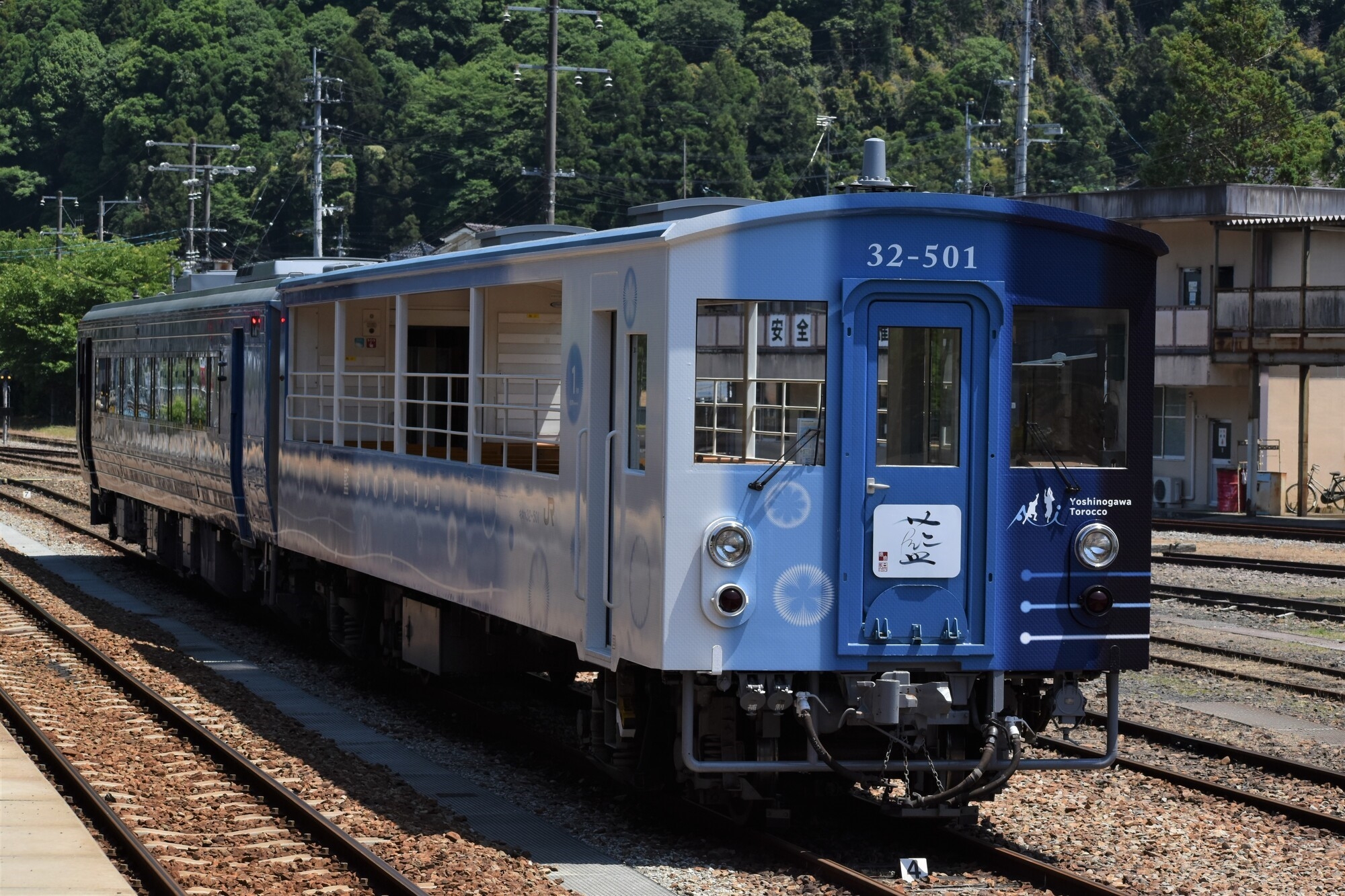 A blue colored train on a rail track