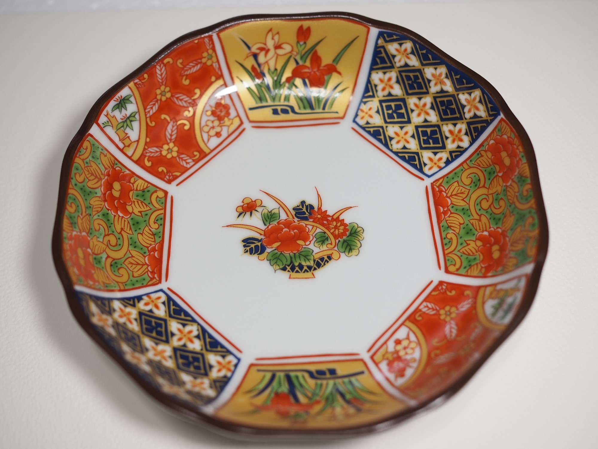 A plate painted in red and gold