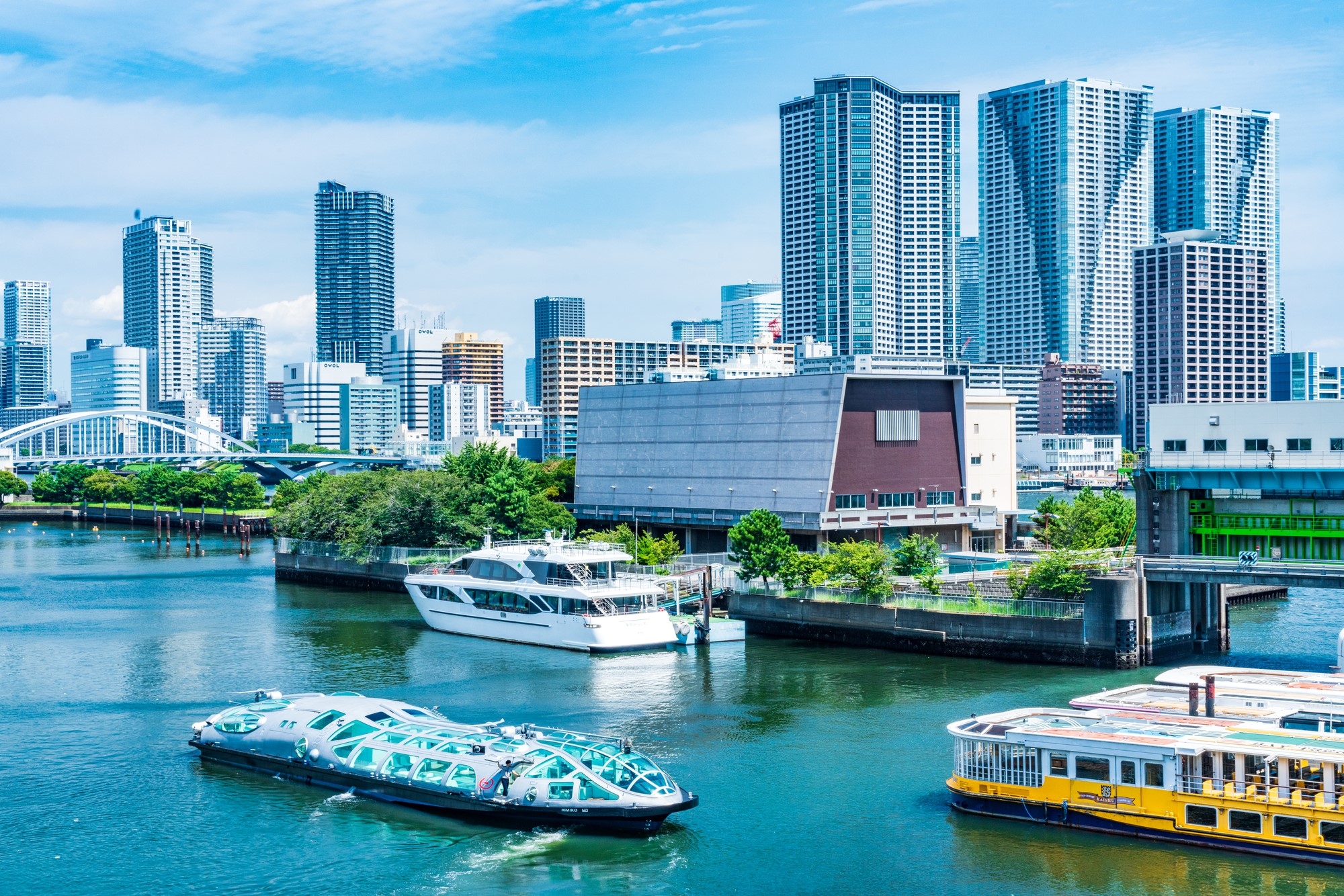 Boats on a river and a view of Tokyo City