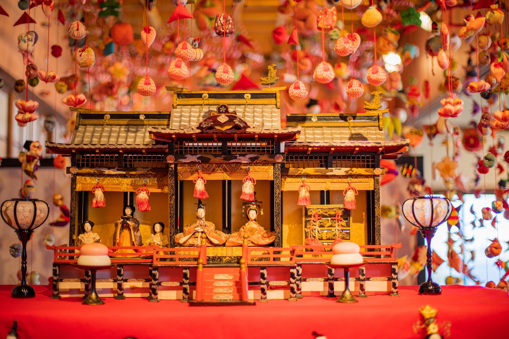 Hanging hina doll decorations and a hina dan