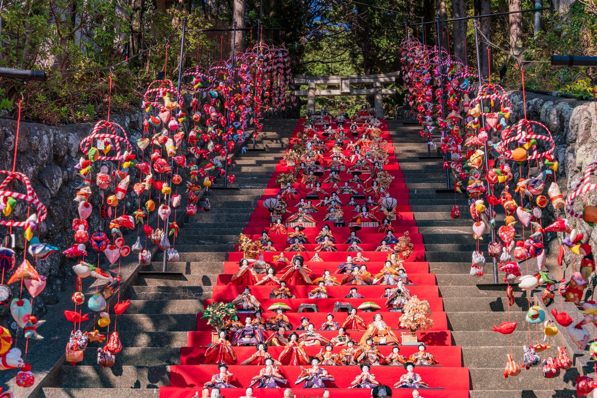 Hanging hina doll decorations and a hina dan on the staircase of Susanoo Shrine