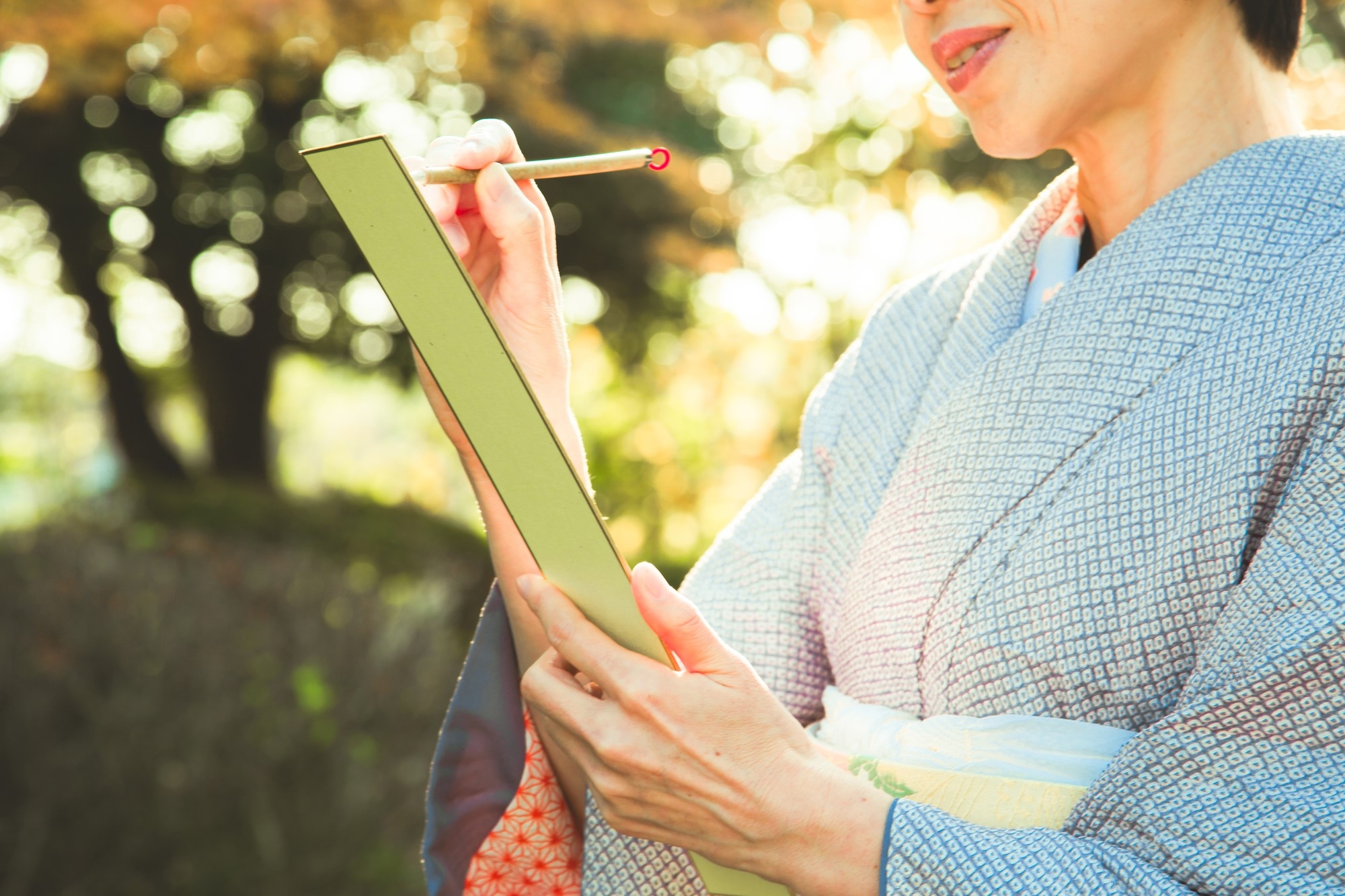 A woman writing a haiku outdoors