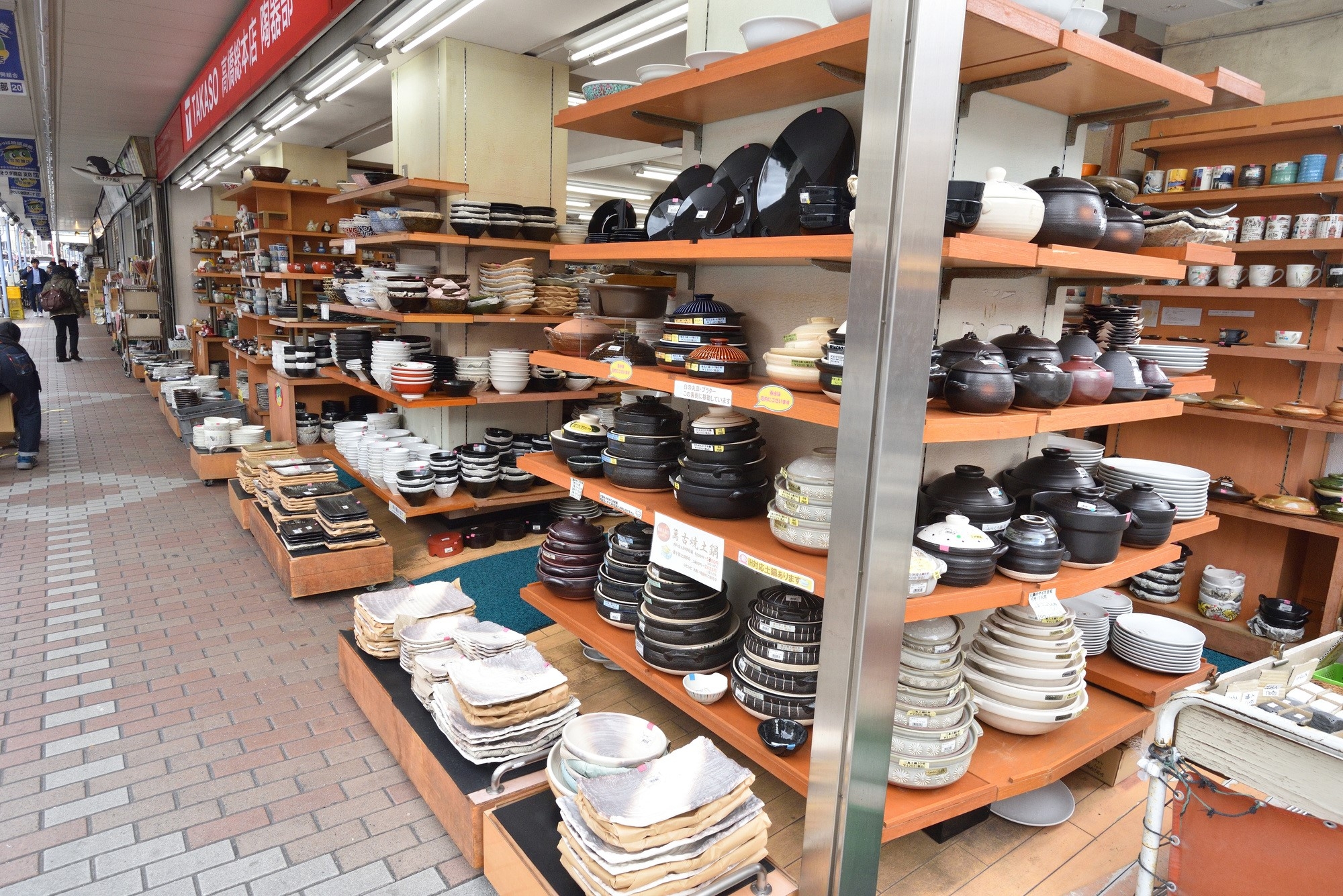 Kitchenware lined up on shelves at Kappabashi street